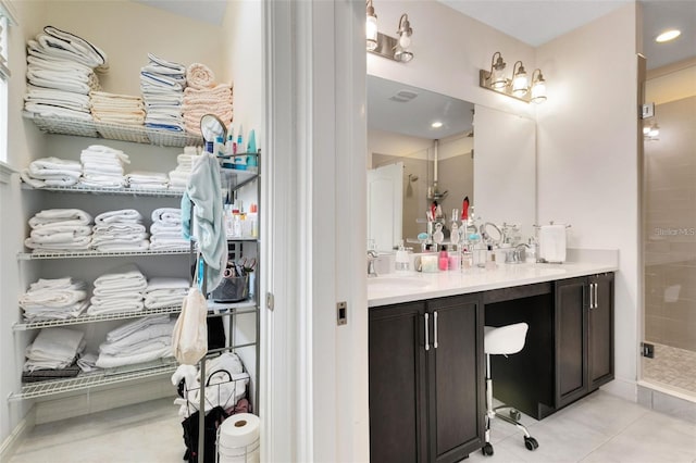 bathroom with vanity, tile patterned floors, and walk in shower