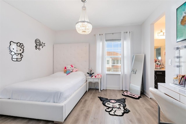 bedroom with a chandelier and light hardwood / wood-style flooring