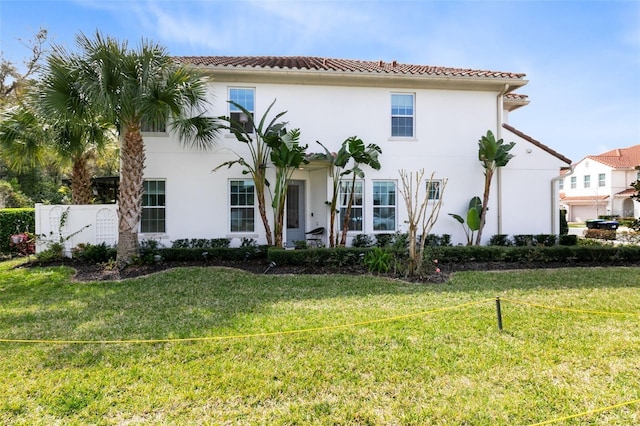 mediterranean / spanish home featuring a front lawn