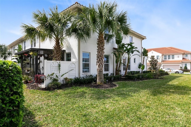 mediterranean / spanish-style house featuring a front yard