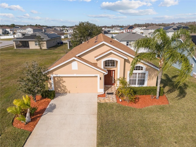 view of front of home featuring a garage and a front yard