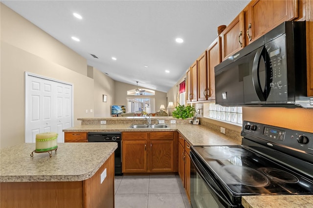 kitchen featuring a wealth of natural light, kitchen peninsula, sink, and black appliances