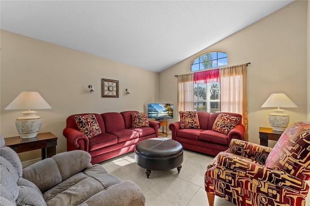 living room with lofted ceiling and light tile patterned floors