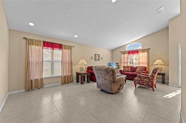 living room featuring light tile patterned floors, a wealth of natural light, and vaulted ceiling