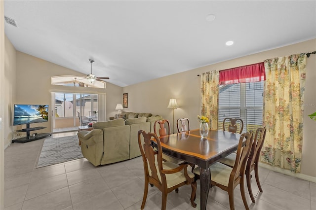 tiled dining space with vaulted ceiling and ceiling fan