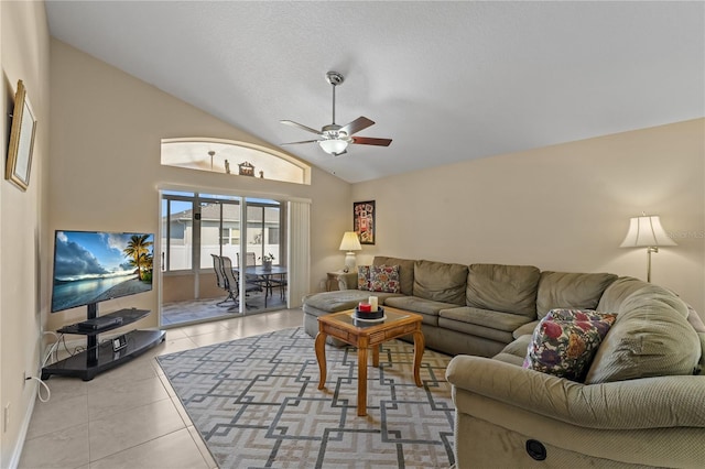 living room with lofted ceiling, light tile patterned floors, and ceiling fan