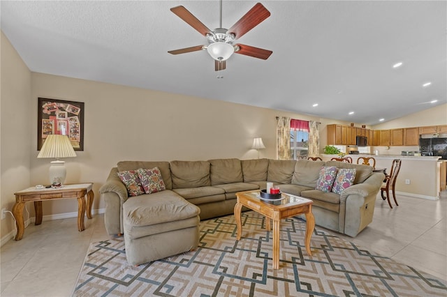 living room with lofted ceiling, light tile patterned floors, a textured ceiling, and ceiling fan