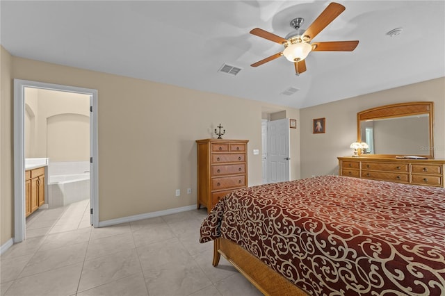 tiled bedroom featuring ceiling fan, lofted ceiling, and ensuite bath