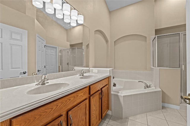 bathroom with tile patterned flooring, vanity, and independent shower and bath