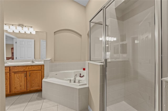 bathroom featuring tile patterned flooring, plus walk in shower, and vanity