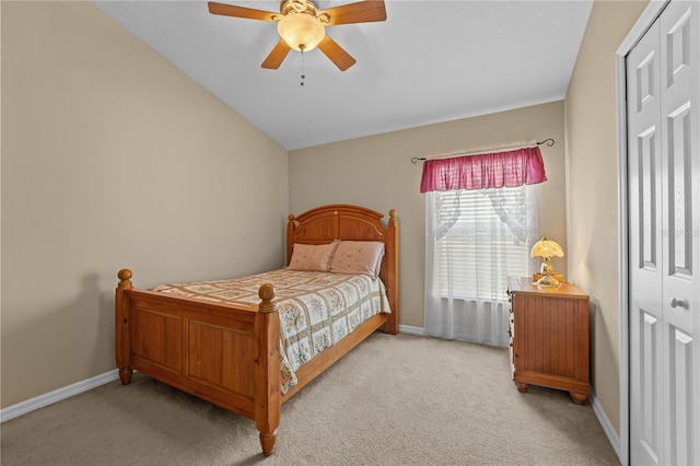 bedroom with ceiling fan, vaulted ceiling, and light carpet