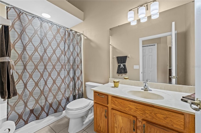 bathroom with vanity, toilet, and tile patterned flooring