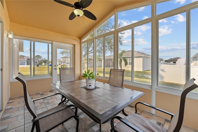 sunroom / solarium featuring lofted ceiling and ceiling fan