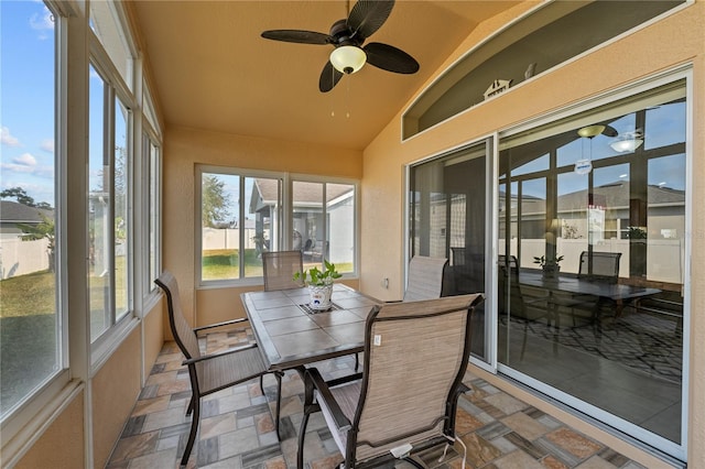 sunroom with lofted ceiling and ceiling fan