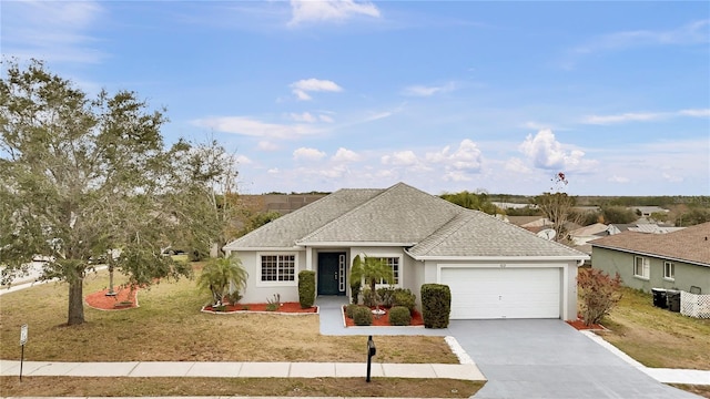 single story home with a garage and a front lawn