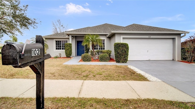 view of front of home with a garage and a front lawn