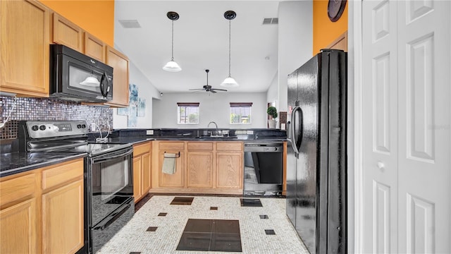 kitchen featuring lofted ceiling, sink, hanging light fixtures, tasteful backsplash, and black appliances