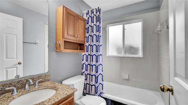 full bathroom with vanity, shower / tub combo, and toilet