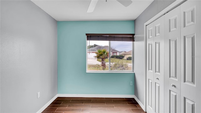 interior space with ceiling fan and a closet