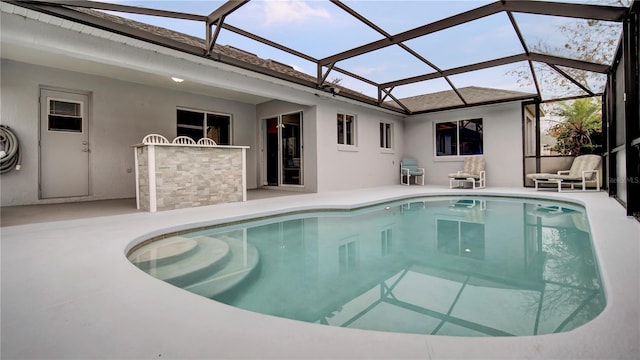 view of pool featuring a patio, a lanai, and an outdoor bar