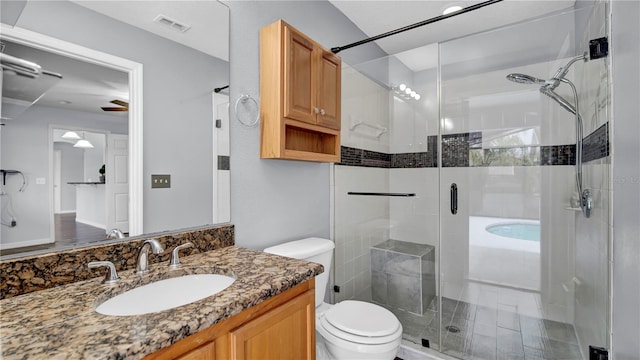 full bathroom with vanity, shower with separate bathtub, and toilet