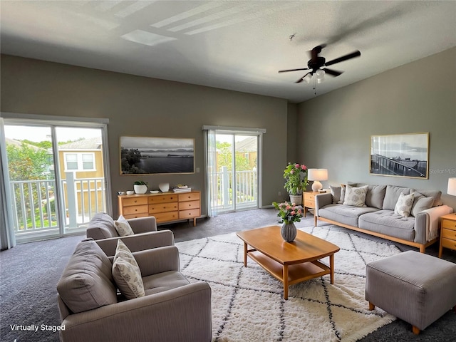 carpeted living room featuring ceiling fan and vaulted ceiling