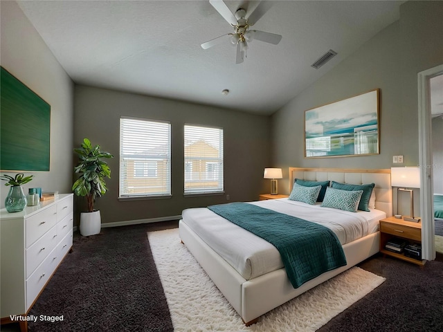 carpeted bedroom with ceiling fan and vaulted ceiling