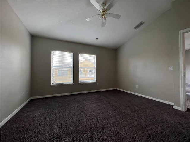 carpeted spare room featuring ceiling fan and lofted ceiling