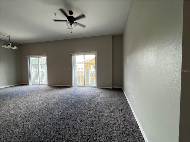 carpeted empty room with ceiling fan with notable chandelier