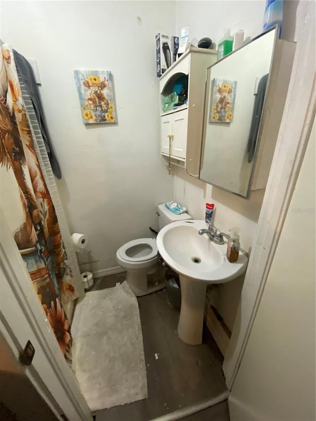 bathroom featuring hardwood / wood-style floors and toilet