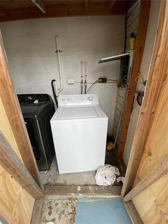 clothes washing area featuring washer and clothes dryer