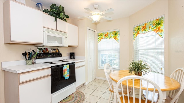 kitchen with range with electric stovetop, white cabinetry, light tile patterned floors, and ceiling fan