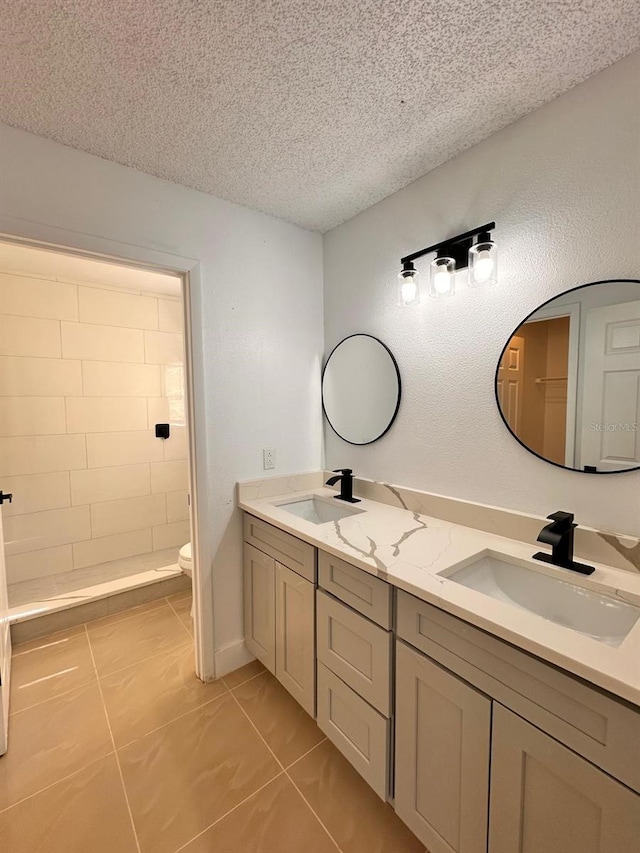 bathroom with walk in shower, vanity, toilet, and a textured ceiling