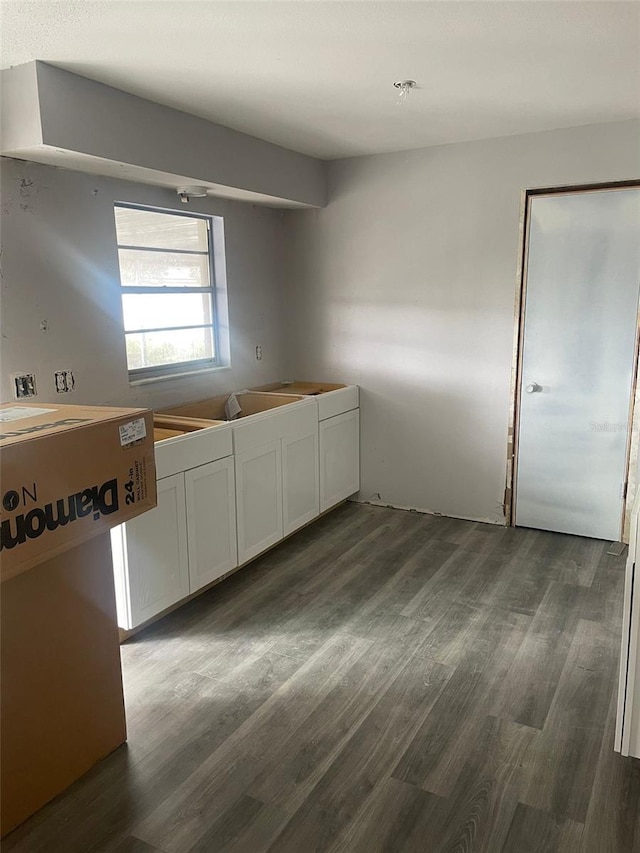 kitchen with dark hardwood / wood-style floors and white cabinets