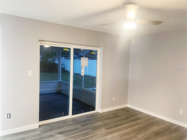 unfurnished room featuring a ceiling fan, baseboards, and wood finished floors