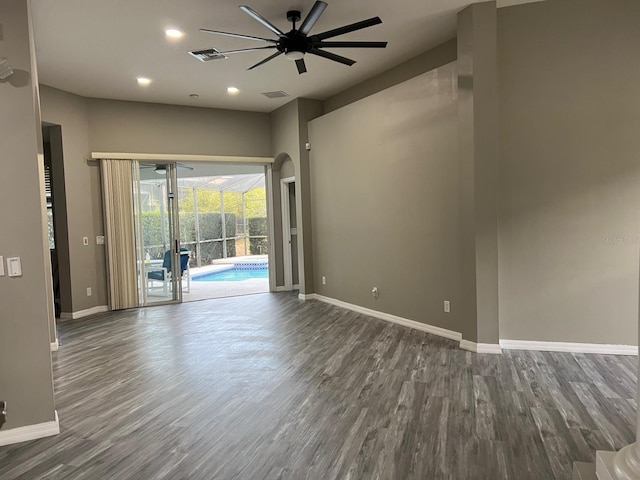 spare room with dark hardwood / wood-style floors and ceiling fan