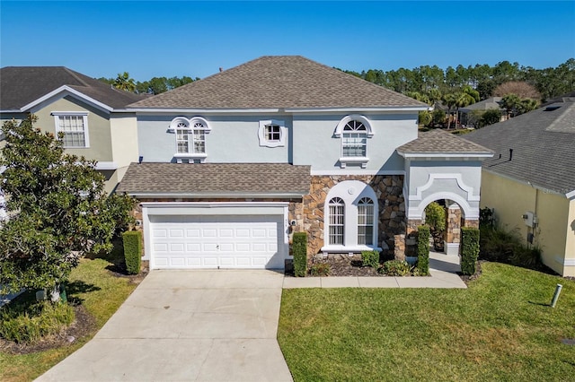 view of front of house featuring a garage and a front lawn