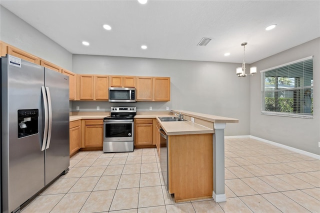 kitchen with sink, light tile patterned floors, appliances with stainless steel finishes, kitchen peninsula, and pendant lighting