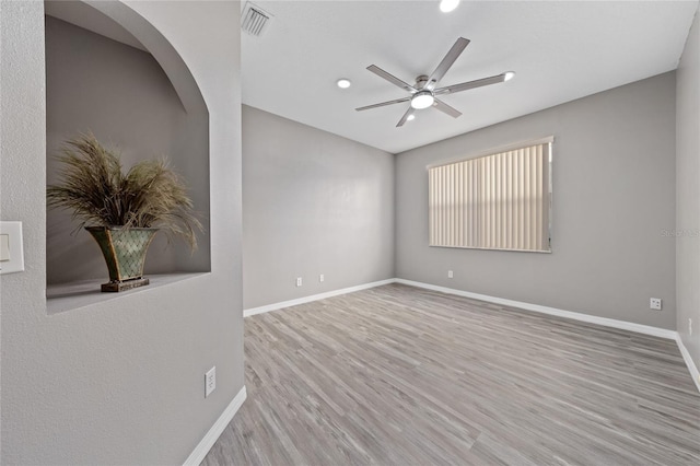 spare room featuring hardwood / wood-style flooring and ceiling fan