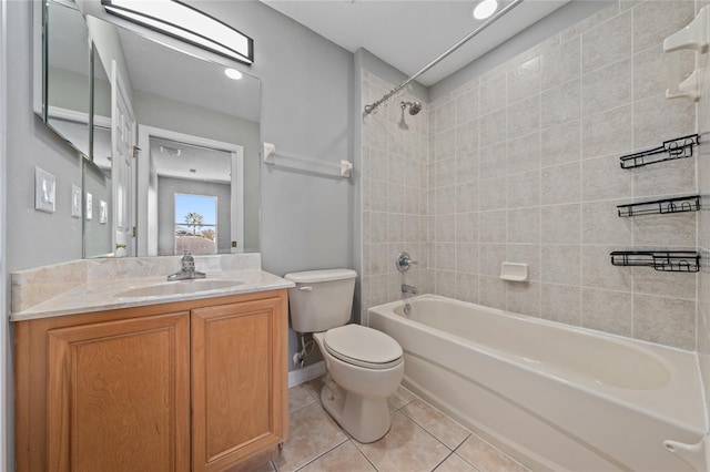 full bathroom featuring tiled shower / bath combo, vanity, tile patterned floors, and toilet