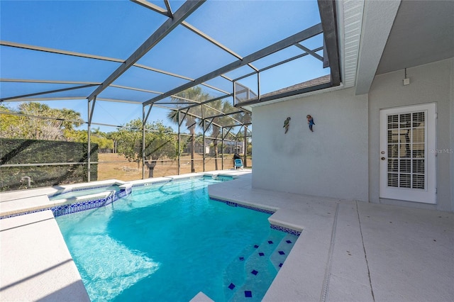 view of pool featuring an in ground hot tub, a lanai, and a patio area