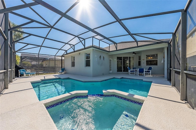 view of swimming pool featuring a lanai, ceiling fan, and a patio area