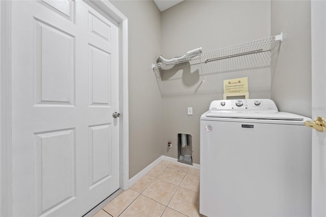 laundry area featuring light tile patterned flooring and washer / dryer