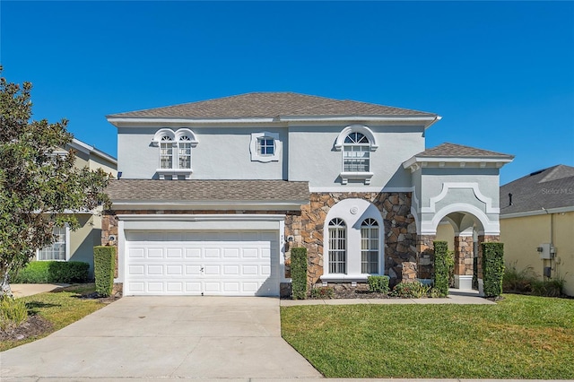 view of front facade with a garage and a front lawn