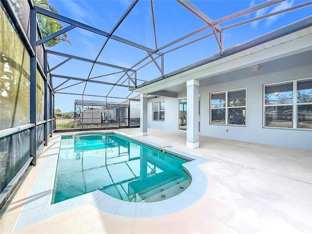 view of swimming pool with a patio and glass enclosure