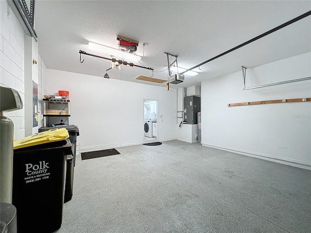 garage with separate washer and dryer and a garage door opener