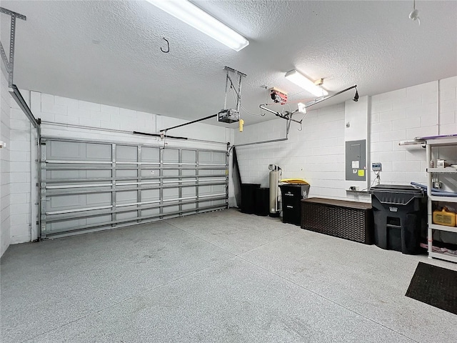 garage with a garage door opener and electric panel