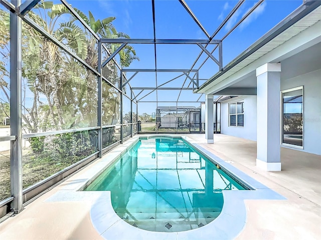 view of pool featuring a patio and glass enclosure