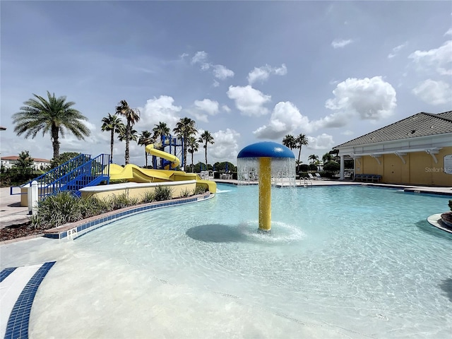 view of pool with pool water feature and a water slide