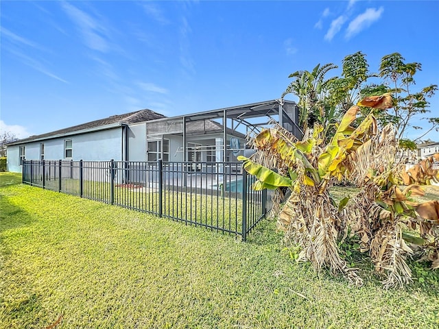 view of yard featuring a fenced in pool and glass enclosure